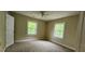 Bedroom featuring neutral carpet and trim with two windows and a door at 1162 Sims St, Atlanta, GA 30310