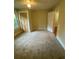 Neutral bedroom offers carpeting, closet with bi-fold doors, and ample natural light from a window at 1162 Sims St, Atlanta, GA 30310