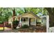 Quaint yellow home showcasing a covered porch, brick chimney, and inviting curb appeal at 1162 Sims St, Atlanta, GA 30310