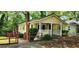 Inviting yellow home with a covered porch, brick chimney, and outdoor access ramp at 1162 Sims St, Atlanta, GA 30310