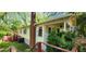 View of the yellow home exterior, back deck, and mature green landscaping at 1162 Sims St, Atlanta, GA 30310