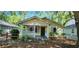 Charming cottage-style home with a covered porch and lush, mature landscaping at 1162 Sims St, Atlanta, GA 30310
