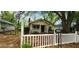Charming single-story home with a yellow exterior, white picket fence and green landscaping at 1162 Sims St, Atlanta, GA 30310