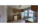 Kitchen area with refrigerator, wood cabinets, a double window, and a sink at 1162 Sims St, Atlanta, GA 30310