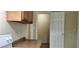 This kitchen has a door leading to another room, and features wood cabinets with a neutral countertop at 1162 Sims St, Atlanta, GA 30310