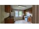 Kitchen featuring white appliances, brown cabinets and countertops with hardwood floors at 1162 Sims St, Atlanta, GA 30310