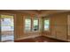Living room includes hardwood floors, a non-operational fireplace and views of the front yard at 1162 Sims St, Atlanta, GA 30310