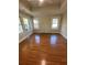 Bright living room with hardwood floors, fireplace, three windows and classic trim detail at 1162 Sims St, Atlanta, GA 30310