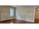 Living room with painted fireplace, window and architectural wainscoting at 1162 Sims St, Atlanta, GA 30310