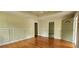 Hardwood floors in the living room lead to a front-facing door and another room at 1162 Sims St, Atlanta, GA 30310