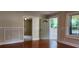 Living room with hardwood floors, wainscoting, and view of entry at 1162 Sims St, Atlanta, GA 30310