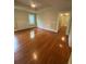 Spacious living room featuring hardwood floors, classic trim detail, and recessed ceiling at 1162 Sims St, Atlanta, GA 30310