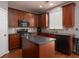 Well-equipped kitchen with dark wood cabinets, stainless steel appliances, and a functional center island at 1535 Justine Se Way, Mableton, GA 30126