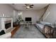 Cozy living room with a fireplace, large windows, and a staircase leading to the upper level at 1535 Justine Se Way, Mableton, GA 30126