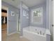 Relaxing main bathroom with a soaking tub, separate shower, and neutral decor at 1535 Justine Se Way, Mableton, GA 30126