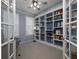 Well-lit home office with built-in bookshelves, french doors, and a neutral color palette at 1535 Justine Se Way, Mableton, GA 30126