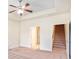 Bedroom featuring carpet and a tray ceiling plus access to a staircase at 1790 Piedmont Ln, Cumming, GA 30040