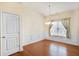 Bright dining room with hardwood floors, chandelier, and wainscoting at 1790 Piedmont Ln, Cumming, GA 30040