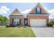 Charming brick home with a well-manicured lawn and two-car garage at 1790 Piedmont Ln, Cumming, GA 30040