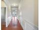 Bright hallway with hardwood floors and detailed wainscoting at 1790 Piedmont Ln, Cumming, GA 30040