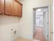 Convenient laundry room with ample cabinet space and access to a walk-in closet at 1790 Piedmont Ln, Cumming, GA 30040