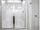 Modern stand-alone shower enclosed with clear glass and metallic trim at 1790 Piedmont Ln, Cumming, GA 30040