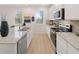 Modern kitchen with white cabinets, stainless steel appliances and granite countertops provide a stylish and functional space at 3064 Steinbeck Way, Atlanta, GA 30344