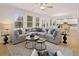 Spacious living room with hardwood floors, a large gray sofa, and abundant natural light creates a cozy atmosphere at 3064 Steinbeck Way, Atlanta, GA 30344