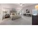 Spacious main bedroom with a large bed, ceiling fan, sitting area, and abundant natural light at 3064 Steinbeck Way, Atlanta, GA 30344