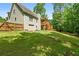 Expansive backyard with lush greenery, a deck, and a well-maintained lawn, perfect for outdoor activities at 596 Deadwood Trl, Locust Grove, GA 30248