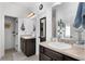 Bright bathroom featuring double vanity, neutral countertops, and framed mirrors above the sinks at 596 Deadwood Trl, Locust Grove, GA 30248
