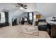 Large bonus room bedroom featuring sloped ceilings, built-in shelving, and a large area rug at 596 Deadwood Trl, Locust Grove, GA 30248