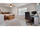 Comfortable bedroom featuring a wood-framed bed and a desk area with a large window at 596 Deadwood Trl, Locust Grove, GA 30248