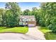 Charming two-story home with brick and siding, set back on a lovely landscaped lot surrounded by mature trees at 596 Deadwood Trl, Locust Grove, GA 30248
