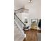 Open foyer featuring a staircase with iron spindles, hardwood floors, and a view of the home's upper level at 596 Deadwood Trl, Locust Grove, GA 30248