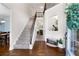 Elegant foyer with hardwood floors, staircase with iron spindles, and an open view into adjacent rooms at 596 Deadwood Trl, Locust Grove, GA 30248