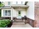 Inviting front porch with charming blue door, decorative plants, and brick accents at 596 Deadwood Trl, Locust Grove, GA 30248