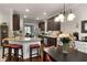Spacious kitchen with granite countertops, dark cabinets, and a breakfast bar with seating at 596 Deadwood Trl, Locust Grove, GA 30248