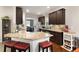 Spacious kitchen features granite counters, an island with seating, and stainless steel appliances at 596 Deadwood Trl, Locust Grove, GA 30248