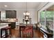 Eat-in kitchen featuring granite countertops, a breakfast bar, a dining area and a view of the deck at 596 Deadwood Trl, Locust Grove, GA 30248
