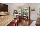 Eat-in kitchen featuring granite countertops, a breakfast bar, a dining area and a view of the deck at 596 Deadwood Trl, Locust Grove, GA 30248