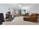Spacious living room featuring neutral tones, comfortable seating, and natural light; ideal for relaxation and entertainment at 596 Deadwood Trl, Locust Grove, GA 30248