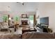 Comfortable living room features a fireplace, large windows and access to the outdoor deck at 596 Deadwood Trl, Locust Grove, GA 30248