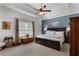 Main bedroom suite with tray ceilings, large window and private ensuite bathroom at 596 Deadwood Trl, Locust Grove, GA 30248
