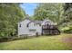 Backyard view showcasing a bright, sunny backyard, deck, and bay window off the back of the home at 115 Jamie Dr, Hiram, GA 30141