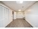 Finished basement with white paneled walls and laminate floors at 115 Jamie Dr, Hiram, GA 30141