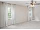 Bedroom with neutral carpet, large windows, and fan with lights at 115 Jamie Dr, Hiram, GA 30141