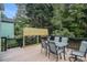 Outdoor deck with a privacy screen, wood flooring and a dining set for outdoor entertaining at 115 Jamie Dr, Hiram, GA 30141