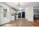 Updated kitchen with light green cabinets, black appliances, and wood-look tile floors at 115 Jamie Dr, Hiram, GA 30141