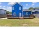 Backyard features a spacious deck and lawn with a blue two-story home in the background at 1598 Jonesboro Se Rd, Atlanta, GA 30315